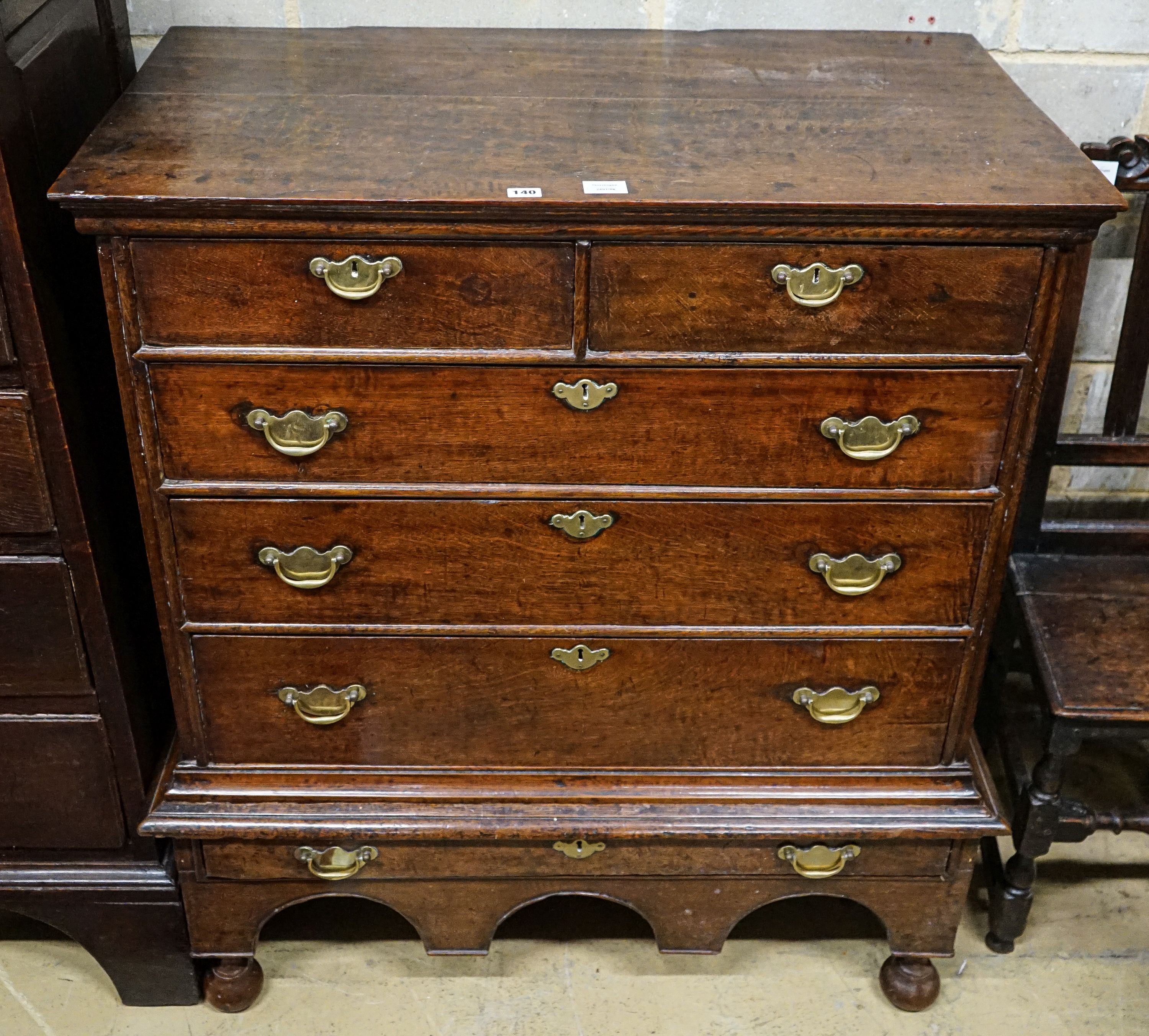 An early 18th century oak chest on stand, fitted two short and four long drawers, width 106cm, depth 56cm, height 117cm
